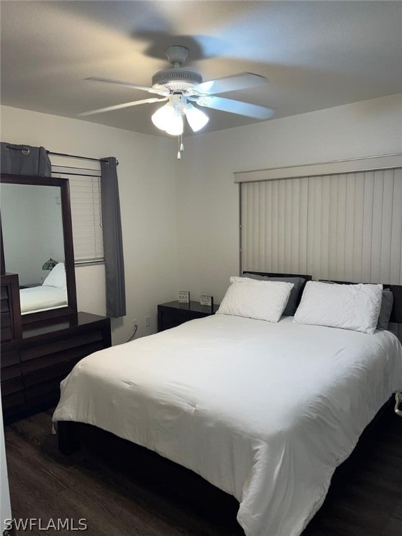 bedroom with ceiling fan and dark hardwood / wood-style floors