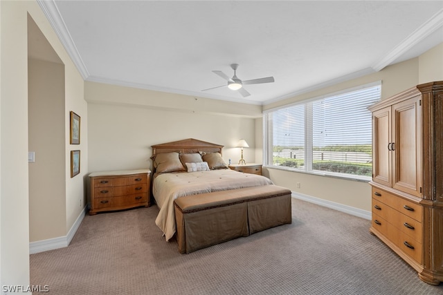 carpeted bedroom with ceiling fan and ornamental molding