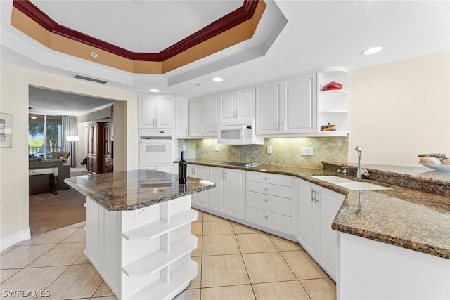 kitchen featuring white cabinets, crown molding, white appliances, and sink