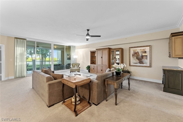 carpeted living room with ceiling fan and crown molding