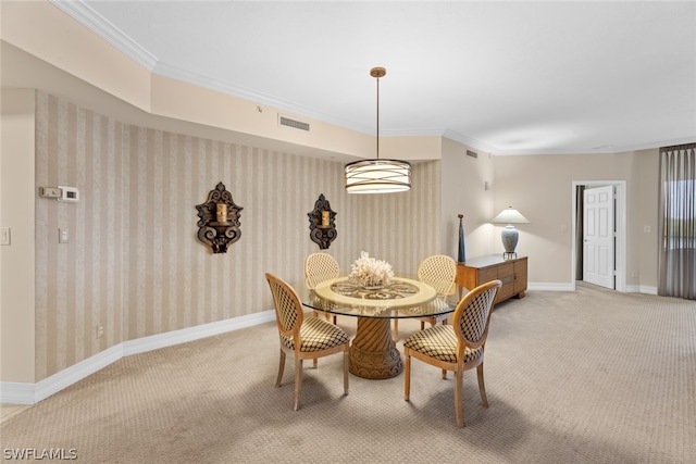 carpeted dining area with crown molding