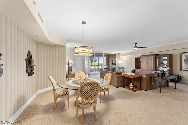 carpeted dining area featuring ceiling fan and ornamental molding