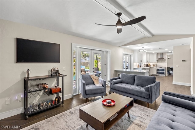 living room featuring french doors, lofted ceiling with beams, baseboards, and wood finished floors
