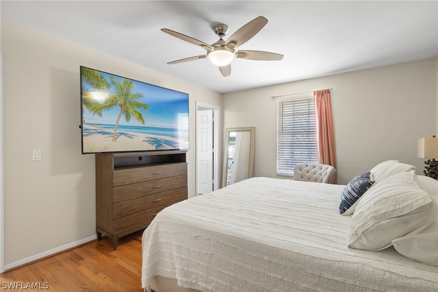 bedroom featuring baseboards, ceiling fan, and light wood-style floors