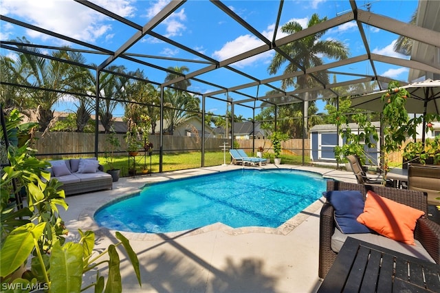 view of pool featuring a patio area, a fenced backyard, outdoor lounge area, and an outbuilding