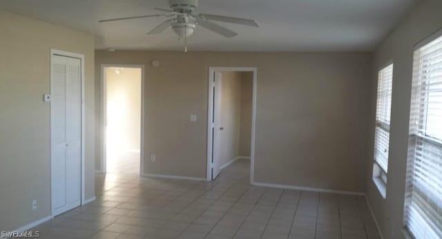 unfurnished room featuring ceiling fan and light tile patterned floors