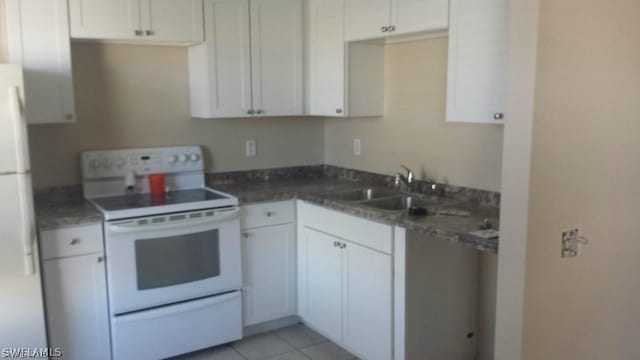 kitchen with sink, white cabinets, light tile patterned flooring, and white appliances