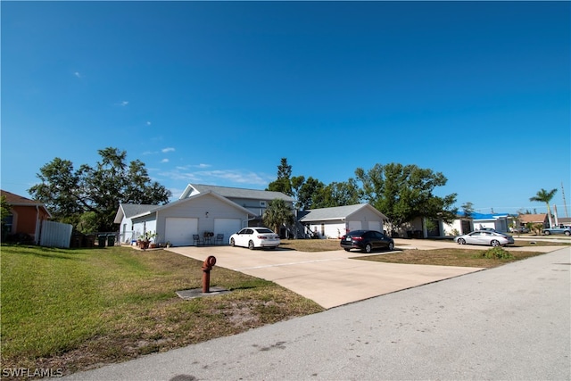 view of front of home featuring a front yard and a garage