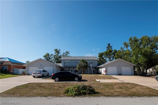 ranch-style house with a garage and a front lawn