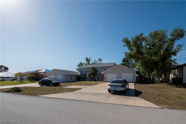 ranch-style house with a garage and a front lawn