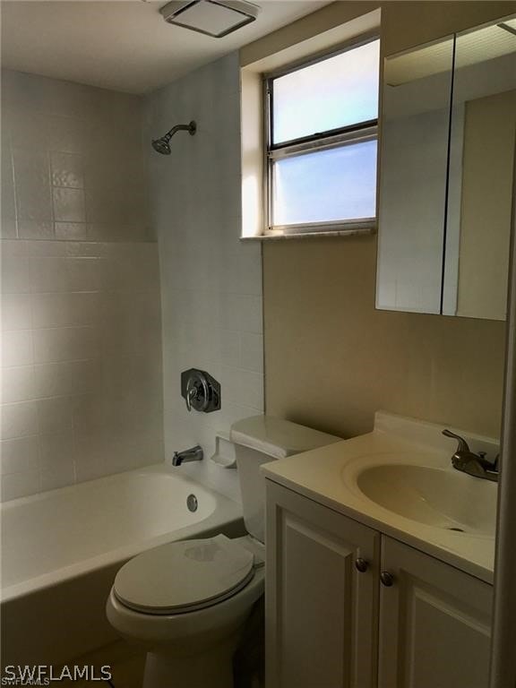 full bathroom with vanity, toilet, and tiled shower / bath