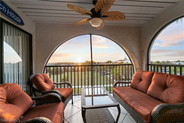 balcony at dusk featuring outdoor lounge area and ceiling fan