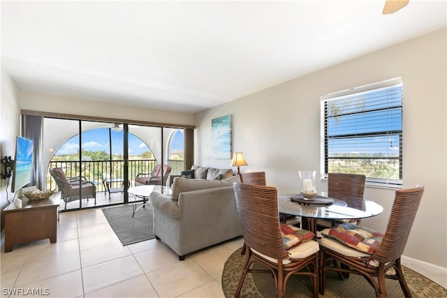 dining space with ceiling fan and light tile patterned floors