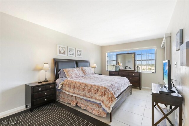 bedroom with light tile patterned floors