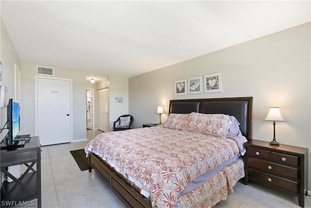 bedroom with light tile patterned floors and a closet