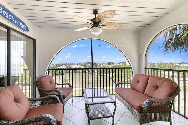 sunroom with tile patterned floors and a textured wall