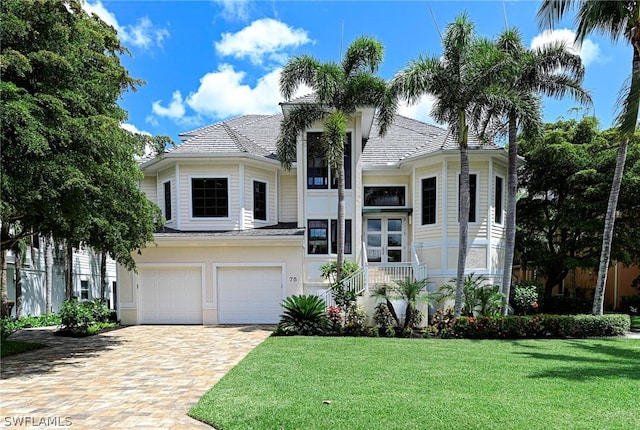 view of front of home featuring a garage and a front yard