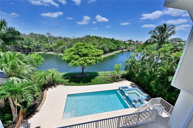 view of swimming pool with a patio area and a water view