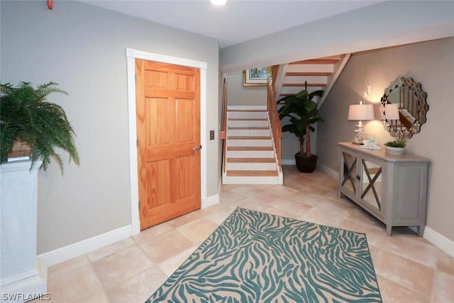 15891 Captiva Dr, Captiva, FL 33924 - entrance foyer with light tile patterned floors, baseboards, and stairway