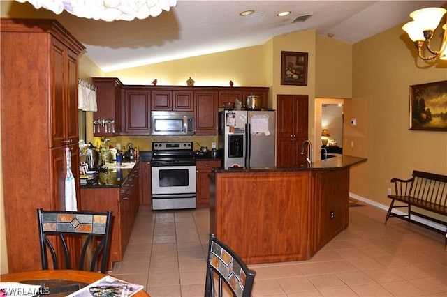 kitchen with stainless steel appliances, a kitchen island, light tile floors, lofted ceiling, and a chandelier