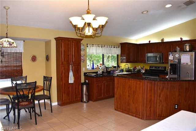 kitchen with decorative light fixtures, appliances with stainless steel finishes, light tile floors, and lofted ceiling