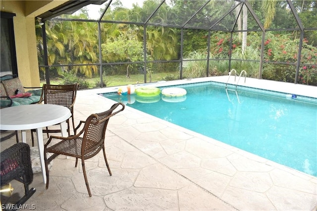 view of swimming pool with a lanai and a patio area