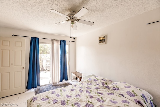 bedroom featuring a textured ceiling, light tile patterned floors, a ceiling fan, and access to exterior