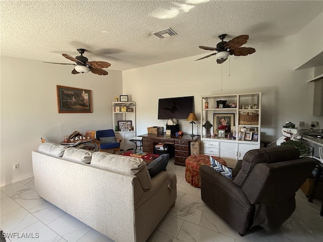 living room featuring a textured ceiling and ceiling fan