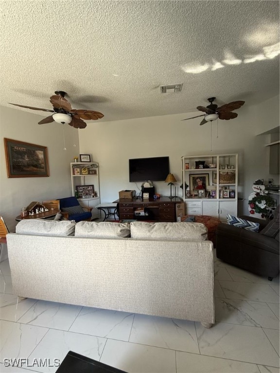 living area with marble finish floor, visible vents, and a ceiling fan