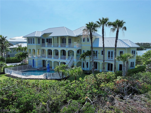 rear view of house featuring a balcony