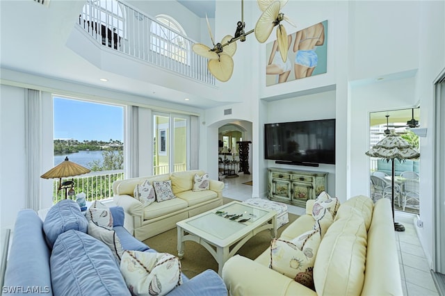 living room featuring tile flooring and a high ceiling