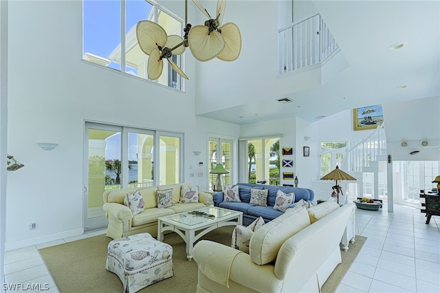 living room with a high ceiling, tile flooring, and french doors