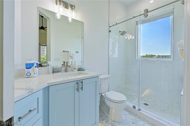 bathroom with ceiling fan, toilet, tile floors, walk in shower, and vanity