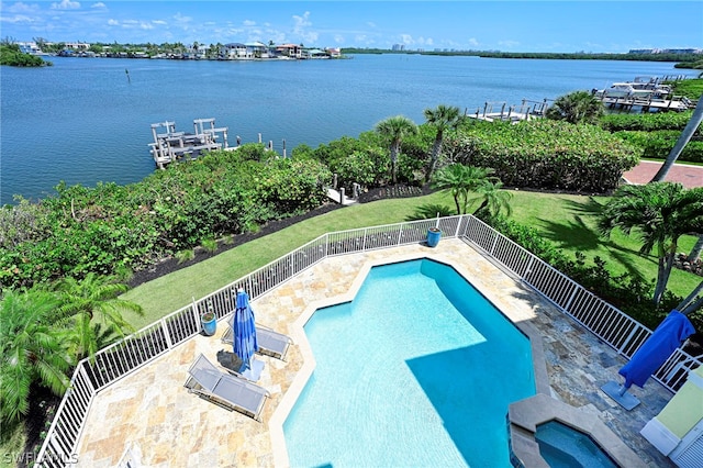 view of pool with a patio and a water view