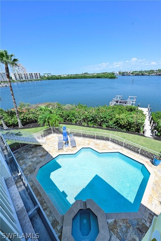 view of pool featuring a patio area and an in ground hot tub