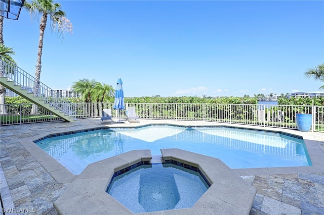 view of pool featuring an in ground hot tub