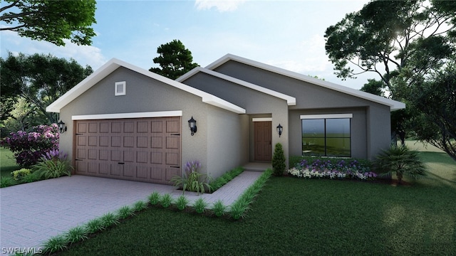 view of front of house featuring a garage and a front lawn