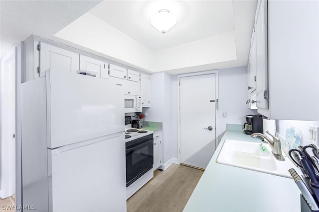 kitchen featuring light hardwood / wood-style floors, white cabinetry, sink, and white appliances