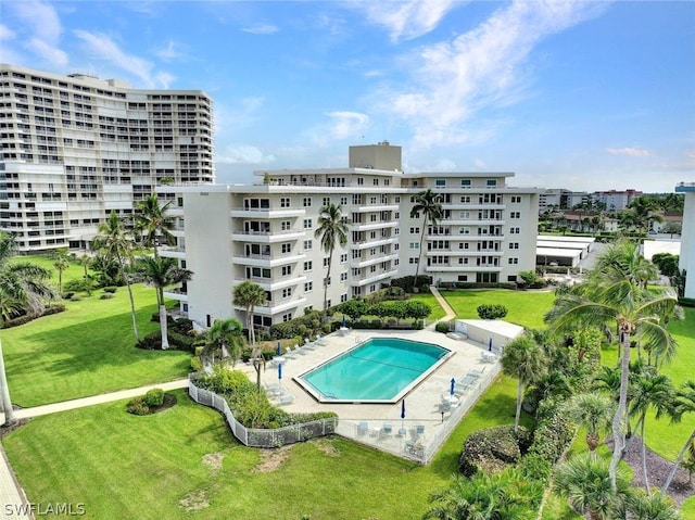 view of pool featuring a lawn