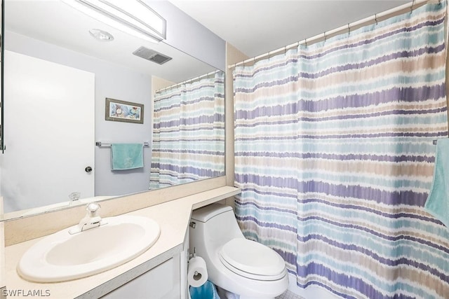 bathroom featuring large vanity and toilet