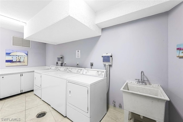 clothes washing area featuring electric dryer hookup, washer and dryer, sink, and light tile flooring