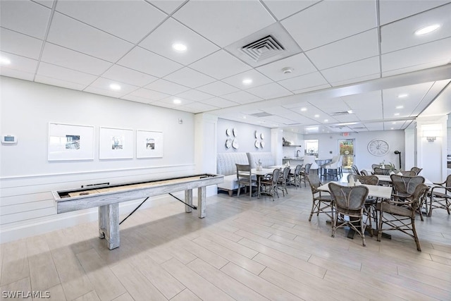 playroom featuring light hardwood / wood-style flooring and a drop ceiling