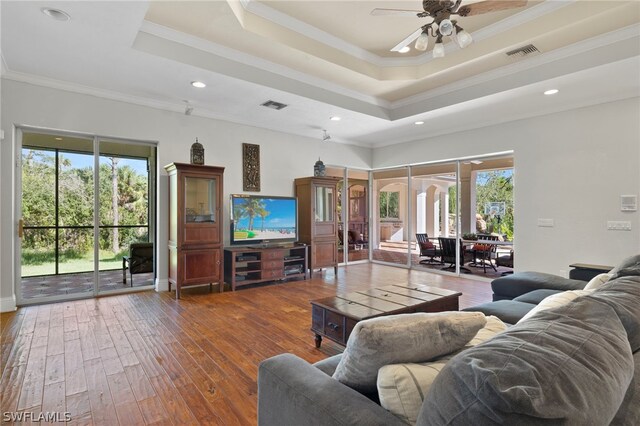 15401 Old Wedgewood Ct, Fort Myers, FL 33908 - living room with crown molding, plenty of natural light, dark hardwood / wood-style floors, and a raised ceiling