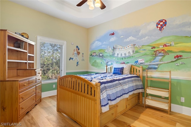 15401 Old Wedgewood Ct, Fort Myers, FL 33908 - bedroom with a tray ceiling, light hardwood / wood-style floors, and ceiling fan