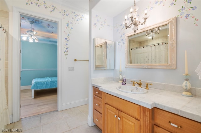 bathroom featuring ceiling fan with notable chandelier, vanity, tile floors, and crown molding