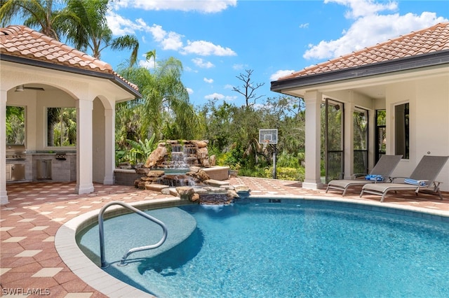 15401 Old Wedgewood Ct, Fort Myers, FL 33908 - view of pool with exterior kitchen and a patio area