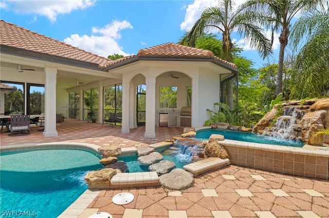 view of swimming pool with ceiling fan, a patio area, and pool water feature