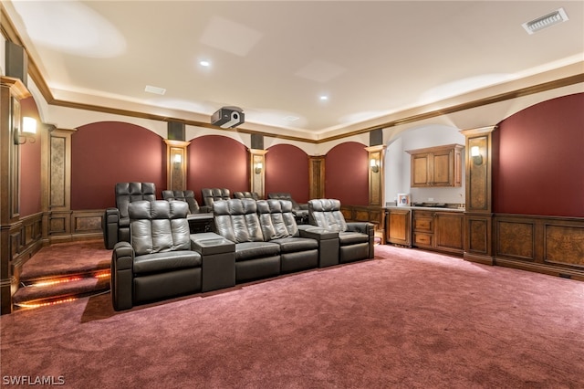 cinema featuring carpet, crown molding, and decorative columns