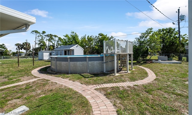 view of yard with a storage unit and a fenced in pool