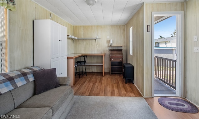 living room with wood walls, hardwood / wood-style floors, and plenty of natural light